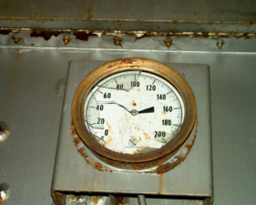 Some sort of gauge on the side of the furnace.