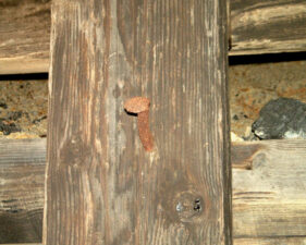 A rusty railroad spike in the tunnel wall. Perhaps it was used to hang a lantern.