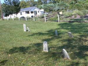 A set of smaller tombstones at the rear of the cemetery.