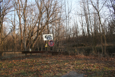 The road dead-ends at this sign where the bridge once stood.