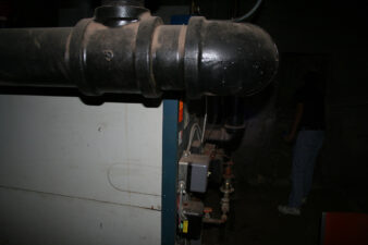 A large piece of equipment inside the old boiler room.