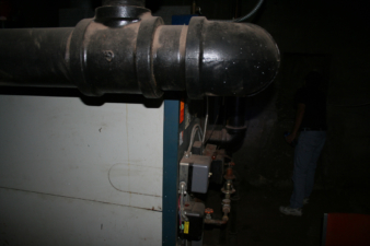 A large piece of equipment inside the old boiler room.