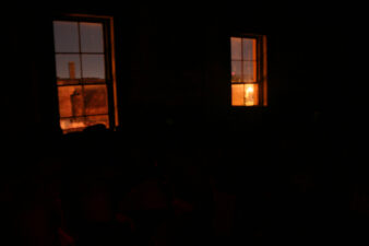 Looking from the darkened ballroom to the city outside.