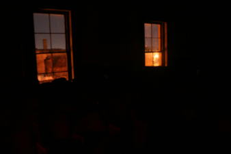 Looking from the darkened ballroom to the city outside.