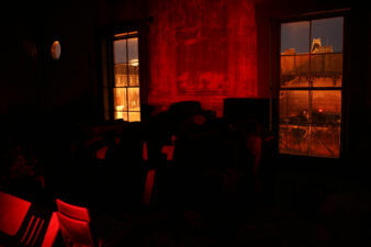 The red glow of the flashlight filled the ballroom.