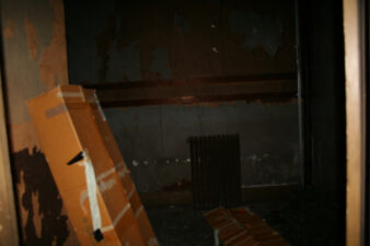 An heating radiator can be seen in the adjacent room.