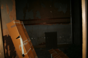 An heating radiator can be seen in the adjacent room.