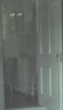 An enlarged view of the doorway so you can see the tall, transparent figure better.