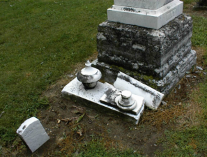 Broken tombstones were next to the large tombstone of Isabella May (1808-1875).