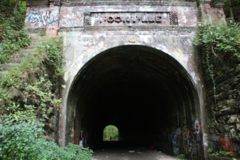 An OES member standing at the far east end of the tunnel.