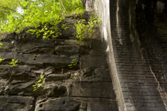 Where the rock foundation meets the brick tunnel.