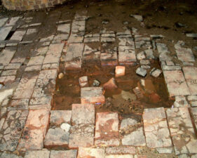 This pit in the middle of the kiln floor was an exhaust vent.
