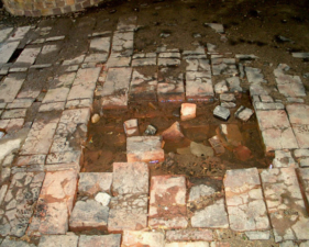 This pit in the middle of the kiln floor was an exhaust vent.