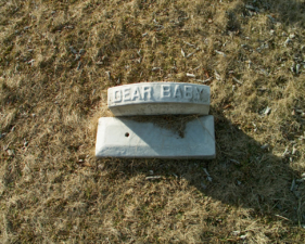 This small stone simply stated "Dear Baby" on top.