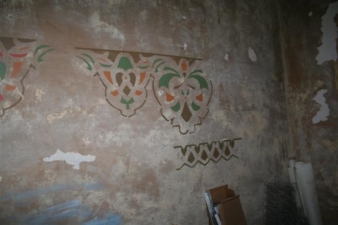Some old stenciling remained on the basement walls.