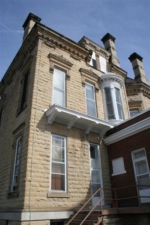 The castle's rear entrance with a bay window on the second floor.