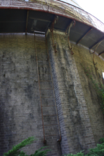 A rusty ladder led up to an exterior catwalk that wrapped around the back of the observatory.
