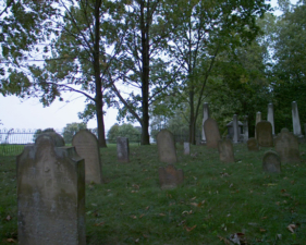 A view of the old tombstones from the rear of the cemetery toward the front.