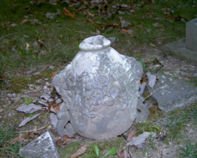 This urn-shaped stone was sitting on the ground. We believe it had been removed from a larger stone.