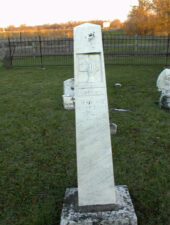 The tombstone of Rebecca Pursel, who died on November 10, 1856. This was the oldest standing stone we found. Notice the broken gate in the background.