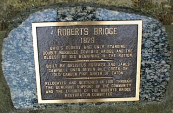 A dedication plaque next to the bridge.