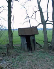 The outhouse was on the edge of the property.