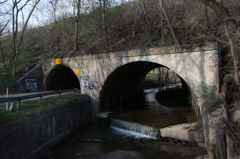 The Schrader Road Tunnel has two sides. One lets Schrader Road pass beneath the railroad tracks and Lick Run flows through the other.