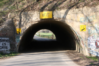 The tunnel was rather low and narrow. Only one vehicle at a time may pass through.