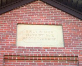 The original plaque above the entry to the school.