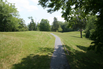 The paved pathway continued on the other side of the mound.