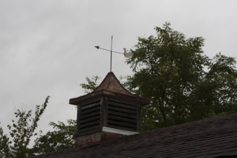 The weathervane atop an attic vent.