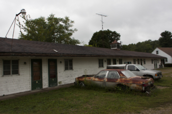 A couple of junk cars sat at the far end of the parking lot. Who knows how long they had been there.