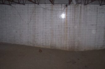 The tiled wall of the pool.