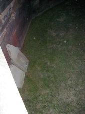 A couple of tombstones were propped against the wall.
