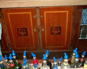 THe cabinets beneath the bar.