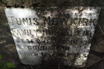 This stone that marked the cemetery's location was embedded in the cement wall.