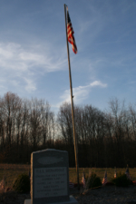 The U.S. flag and memorial stone.