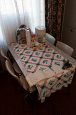 The dining room table with a modern coffee maker.