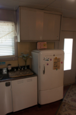 The home's back door was on the side of the house next to the refrigerator.