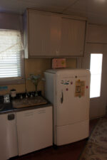 The home's back door was on the side of the house next to the refrigerator.