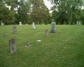 The back corner of the cemetery.