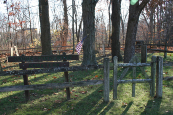 The cemetery's sign and surrounding fence.